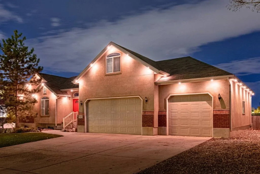 Home at dusk with warm white accent lights over the garage