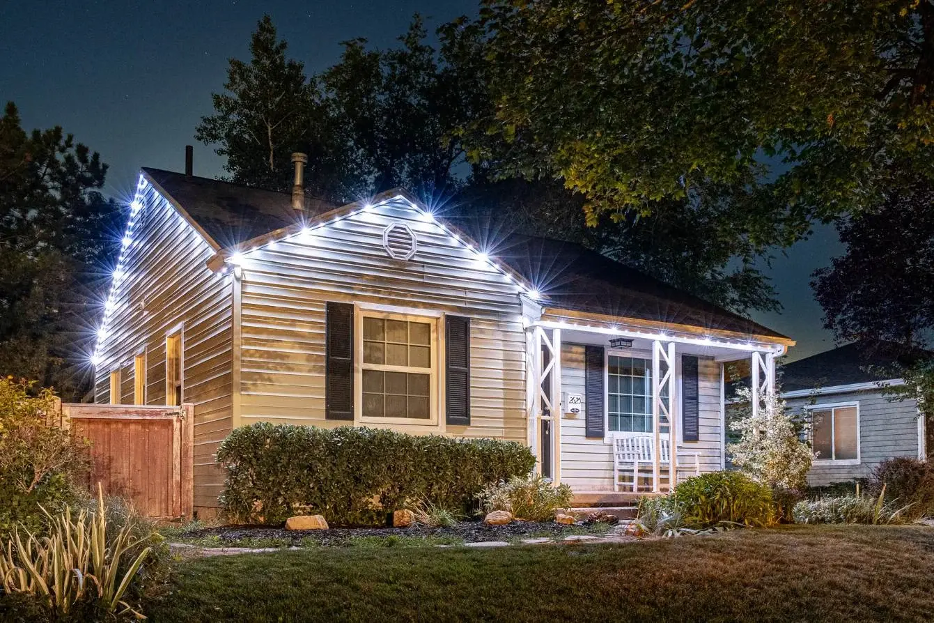 Single-story home at dusk with white accent lights along the roofline